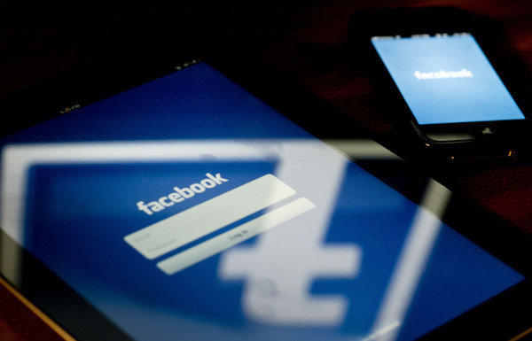 A view of an Apple iPad and iPhone displaying the Facebook app's splash screen May 10, 2012 in Washington, DC. Social-networking giant Facebook will go public on the NASDAQ May 18 with its initial public offering, trading under the symbol FB, in an effort to raise $10.6 billion. AFP PHOTO / Brendan SMIALOWSKI (Photo credit should read BRENDAN SMIALOWSKI/AFP/GettyImages)